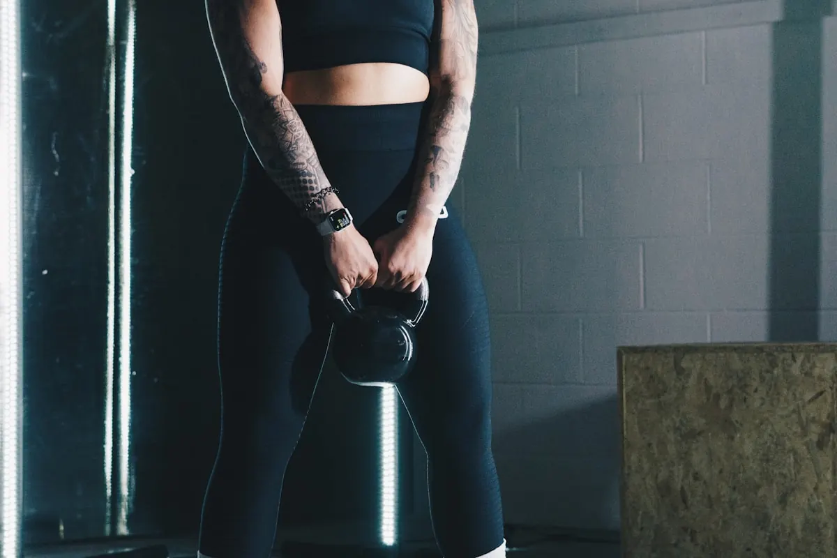 Member holding a kettlebell at the top of a deadlift