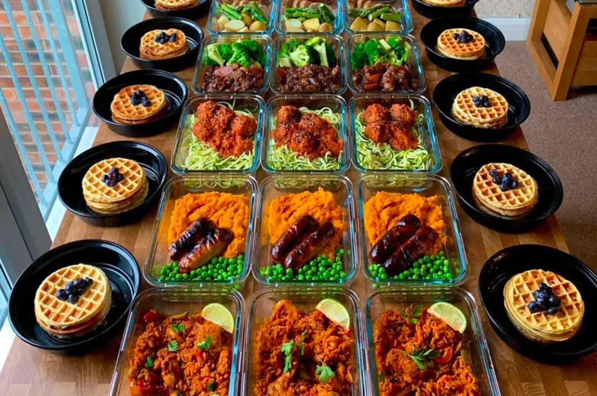 A week of meal prep containers laid out on a counter by a member